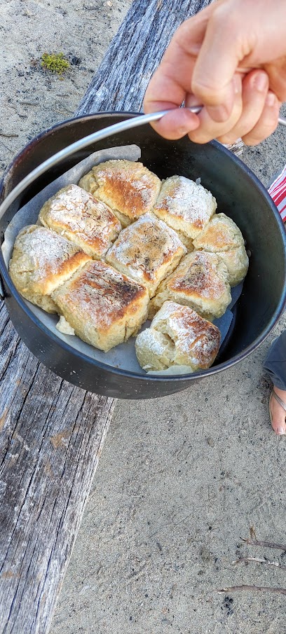 Scones cooked in a camp oven with coals from a camp fire.